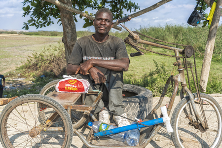 SUMBE/ANGOLA - 28OCT2017 - Portrait of African rural street vendor.のeditorial素材