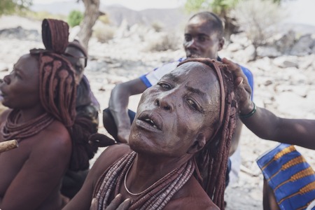 NAMIBE/ANGOLA - 28 AUG 2013 - Portrait of African elderly woman belonging to a tribe smoking with pipe.のeditorial素材