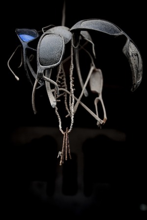 Set of sunglasses old and dusty by a rope, viewed from below.の写真素材
