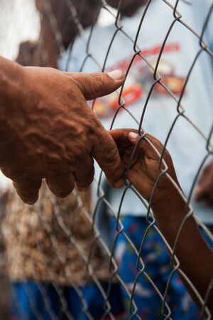 man to give hand to child needed in africa.の写真素材