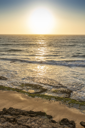 Beautiful sunset on the wild beach of the Namib Desert. Angola. Africa.の写真素材