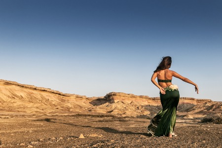 Active woman dancing on plain of the Namibe Desert. Africa. Angola.の写真素材