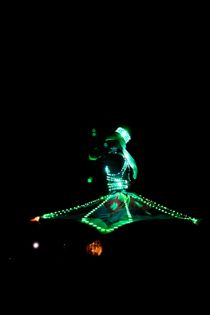 ABUDHABI/UAE - 17 DEZ 2018 - Traditional Arabic dance in Abu Dhabi, man dancing with dark environment and suit with green lights.のeditorial素材
