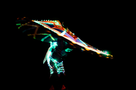 ABUDHABI/UAE - 17 DEZ 2018 - Traditional Arabic dance in Abu Dhabi, man dancing with dark environment and suit with green lights.のeditorial素材
