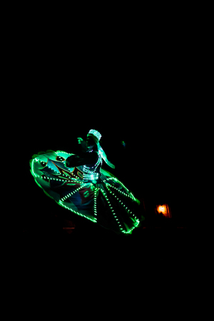 ABUDHABI/UAE - 17 DEZ 2018 - Traditional Arabic dance in Abu Dhabi, man dancing with dark environment and suit with green lights.のeditorial素材