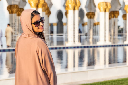 UAE/ABUDHABI - 15 DEZ 2018 - Woman with burqa in great mosque.のeditorial素材