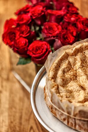 Portuguese traditional cake, sponge cake. on the wooden table with roses.の写真素材