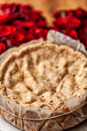 Portuguese traditional cake, sponge cake. on the wooden table with roses.の写真素材