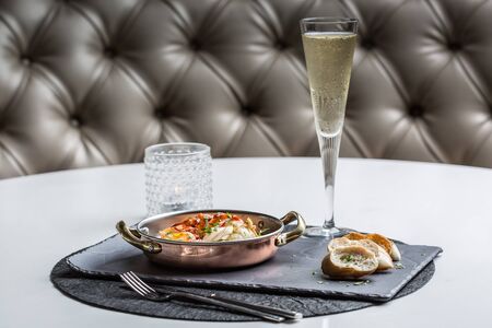 Beautiful giant lobster loin with coriander sauce and bread slices and champagne glassの写真素材