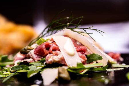 Beautiful carpaccio with cheese and vegetables.の写真素材