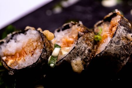 Sushi Roll viewed from above. On black stone.の写真素材