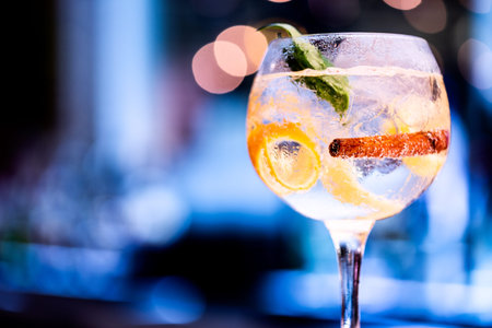 Beautiful glass of gin on bar counter, with blurred background. Hero perspective .の写真素材