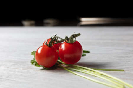 cherry tomatoes on wooden tableの写真素材
