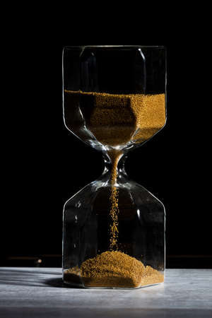 hourglass of time isolated on black background.の写真素材