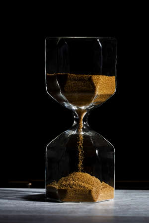 hourglass of time isolated on black background.の写真素材