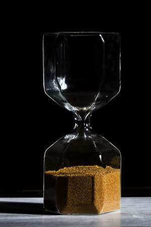 hourglass of time isolated on black background.の写真素材
