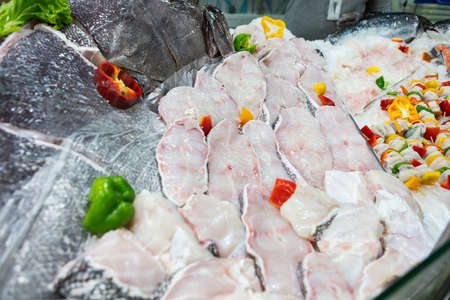 Fishmonger shelf in supermarket with fresh fish.の写真素材