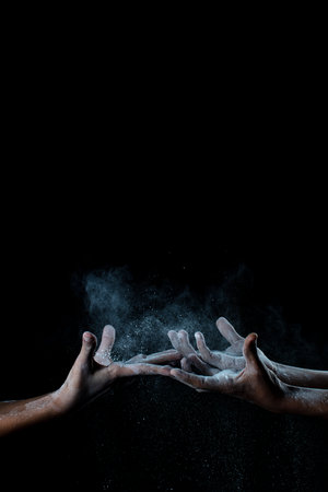 African man hands interacting with flour or powder.の写真素材
