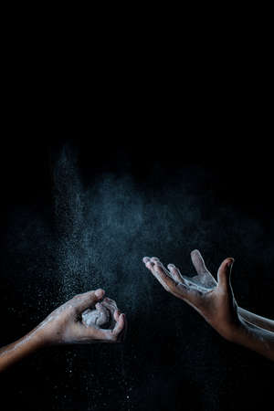 African man hands interacting with flour or powder.の写真素材