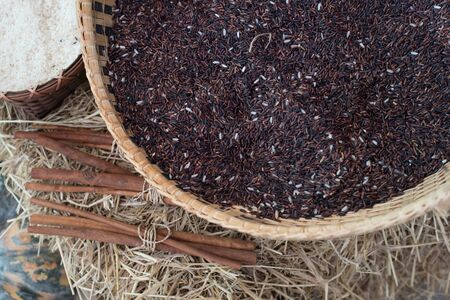 Brown rice grains in the basketの写真素材