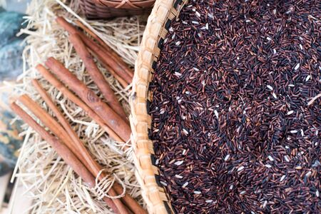 Brown rice grains in the basketの写真素材