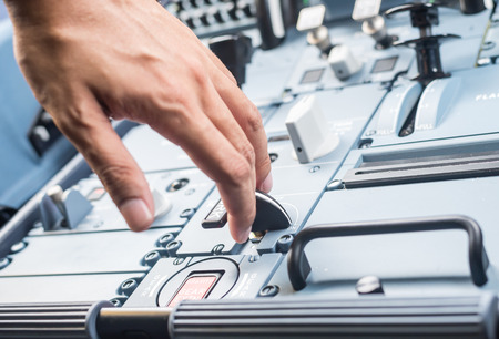 Thailand - June 2015: Airbus A320 Hand on the aircraft instrument panel focus at the panel buttonのeditorial素材
