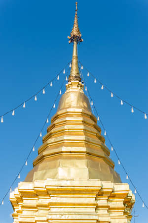 Golden pagoda with blue sky backgroundの写真素材