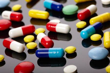 Colorful pills over dark background