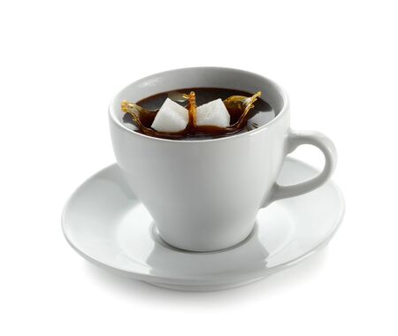 Cup of coffee with falling sugar cubeの写真素材