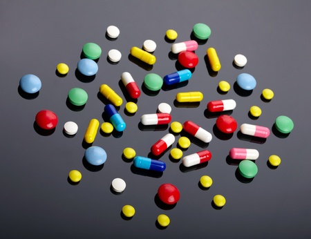 Colorful pills over dark backgroundの写真素材