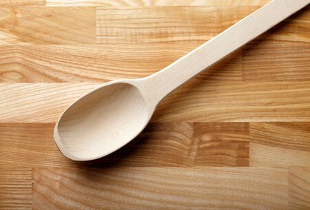 Wooden spoon over wooden backgroundの写真素材