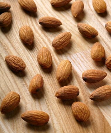 Almonds on wooden backgroundの写真素材