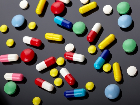 Colorful pills over dark backgroundの写真素材