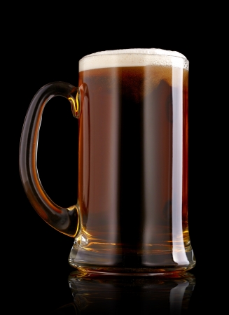 Mug of beer over black backgroundの写真素材
