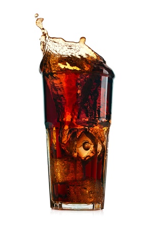 Splashing cola in glass. Isolated on white backgroundの写真素材
