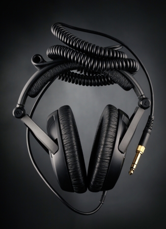 Modern headphones over black backgroundの写真素材