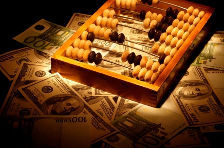 Old abacus on dollars and euro backgroundの写真素材