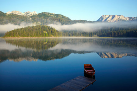 Landscape with mountains, lake and boat