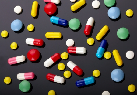 Colorful pills over dark backgroundの写真素材