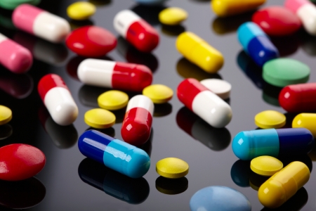 Colorful pills over dark backgroundの写真素材