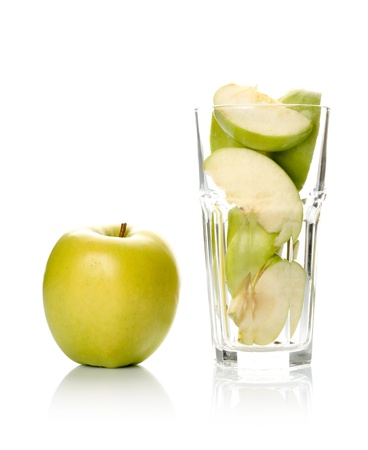 Apple and slices in glass isolated on white background の写真素材