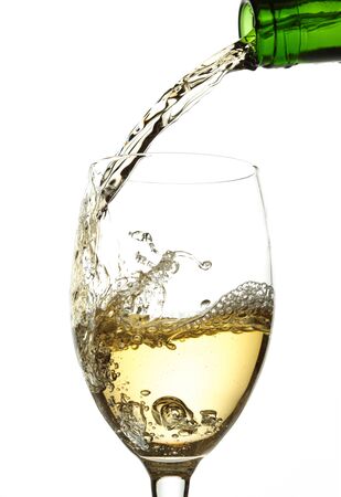 White wine pouring into glassの写真素材