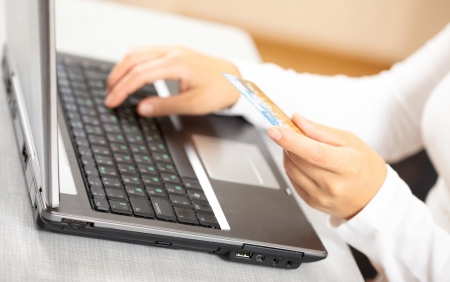 Hands holding credit card and laptop. Shallow DOF の写真素材
