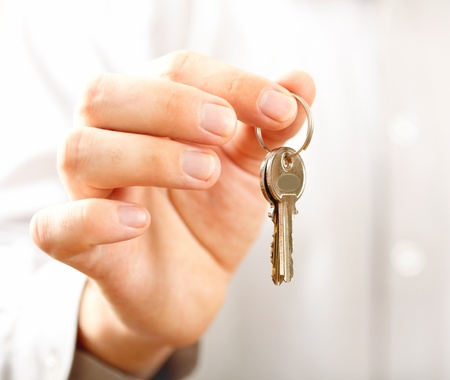 Man holding key. Shallow DOF, focus on key の写真素材