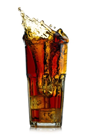 Splashing cola in glass. Isolated on white backgroundの写真素材