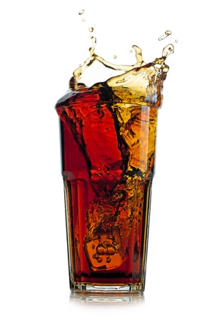 Splashing cola in glass. Isolated on white backgroundの写真素材