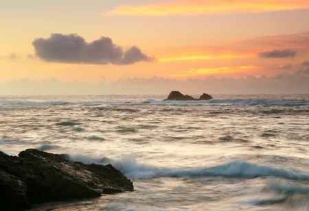 Landscape with ocean, roks and sunset skyの写真素材