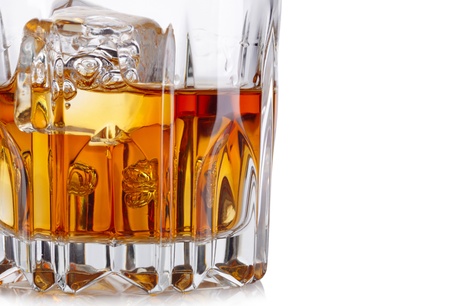 Glass of whiskey and ice isolated on white backgroundの写真素材
