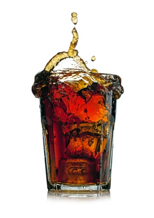 Splashing cola in glass. Isolated on white backgroundの写真素材
