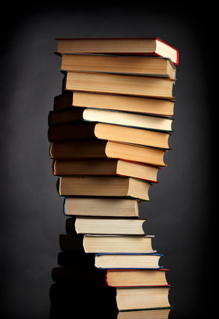 Pile of books on a black background の写真素材